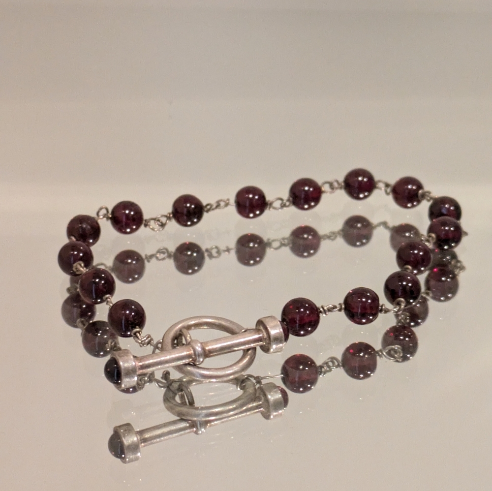 Genuine sterling silver and garnet toggle bracelet